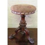 A Victorian piano stool on carved supports