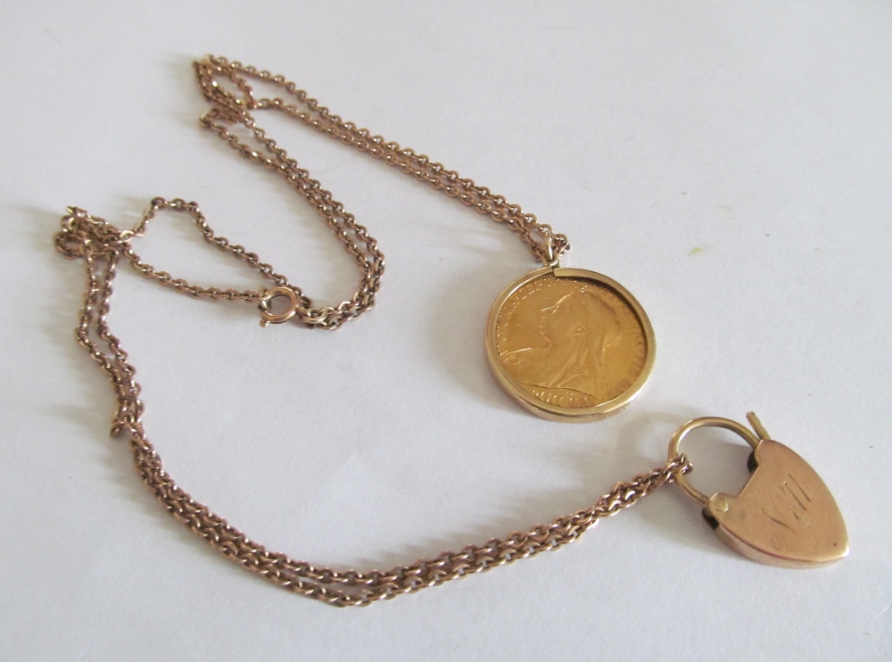 A mounted sovereign pendant on chain with padlock