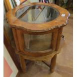 A walnut circular vitrine table