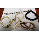 Four designer bead bracelets and a necklace