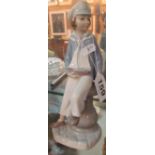 A Lladro boy with boat and boy and girl with candle (a/f)