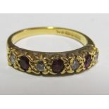 An 18ct gold garnet and diamond ring 2.9g Size L