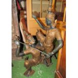 A bronze group two Thai figures balancing in two sections held together by stabilising stick 32"