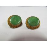 A pair of silver gilt clip on earrings green hardstone centre