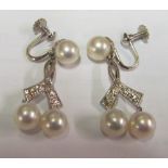 A pair pearl clip earrings with a double pearl drop the screw head marked TYL25 and 14K 585