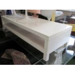 A modern long white coffee table with shelf under 15.5”