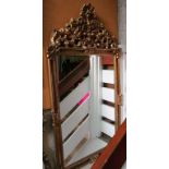 A large gilt framed mirror with shell and fruit cresting 48.5”h x 26.5”w