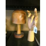 A wig stand with model hand