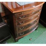 A mahogany and walnut bow front chest with brushing slide above four graduated drawers and bracket