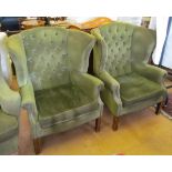 A pair of button upholstered wing armchairs on straight supports