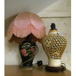 A cream oriental pierced lamp and another flowers on a black ground