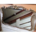 A shaped gilt framed mirror 37”w