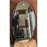 An oval frameless mirror