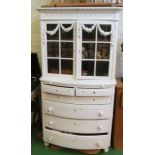 A white painted Edwardian cabinet glazed top over four short and three long drawers with rose