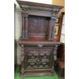 A Victorian small oak dresser with lion ring heads to carved cornice, carved back with two carved