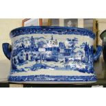 A reproduction blue and white pottery footbath decorated 18th Century town scene