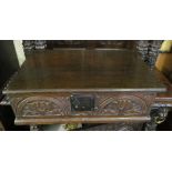 An 18th Century oak bible box with carved arched front