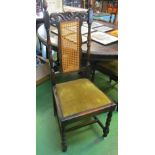 A set of four 1920s oak and cane back dining chairs