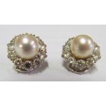 A pair of 1960s pearl and brilliant cut diamond cluster clip on earrings