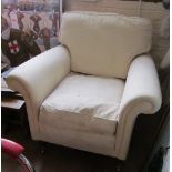 A cream upholstered two seater settee and a similar armchair