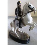 A Beswick Lippizzaner rearing horse and rider No 2467 (cracks to hoofs where they join base,