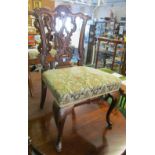 A set of six heavily carved mahogany Chippendale style dining chairs