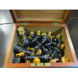 An ebony and boxwood chess set 3 1/2" (three larger black pawns and five smaller and a leather