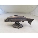 A silver clad model of a fish on naturalistic base 12" length