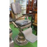 A Barber's chair (back rest worn)