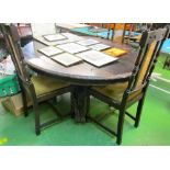 A Victorian oak tip-up action circular dining table on heavy carved column and scroll quadruple