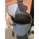 A vintage corrugated metal wash tub with wash board back and soap dish to side