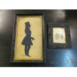 A shillouette of a 19th Century gentleman in frock coat and a photograph Victorian lady in carved