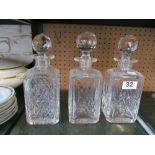 A set of three glass decanters