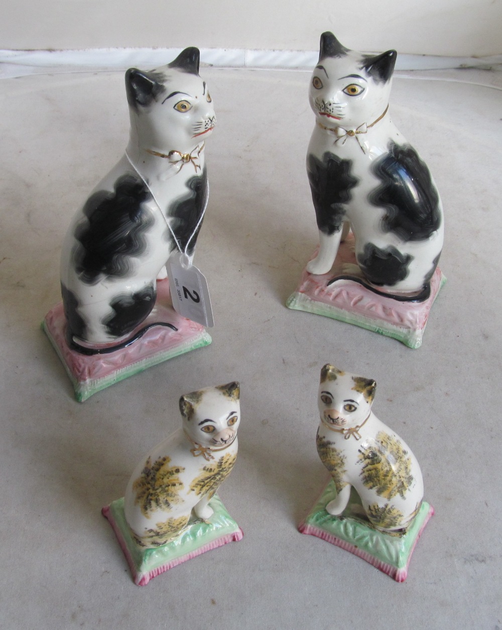 A pair of Victorian Staffordshire cats (both a/f) and a smaller pair