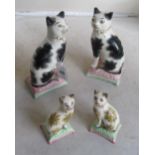 A pair of Victorian Staffordshire cats (both a/f) and a smaller pair