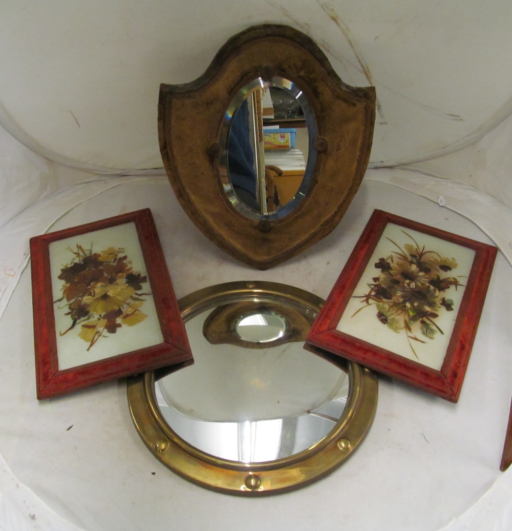 A brass framed convex mirror, a shield shaped velvet framed mirror and two opaque plaques painted