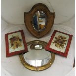 A brass framed convex mirror, a shield shaped velvet framed mirror and two opaque plaques painted