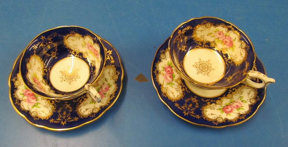 Two Coalport cups and saucers floral design c1890-1910