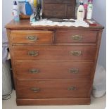 An Edwardian walnut chest of drawers