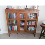 A early 20th century oak display case in Jacobean style on turned legs (glass missing)