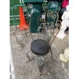 A set of three 1950's metal garden chairs with heart shape scroll backs