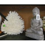 A piece coral and a small statue Buddha