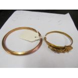 A 9ct gold bangle and a gold coloured South Africa bangle (marked 18ct)
