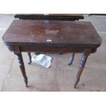 A 19th Century mahogany card table on turned legs