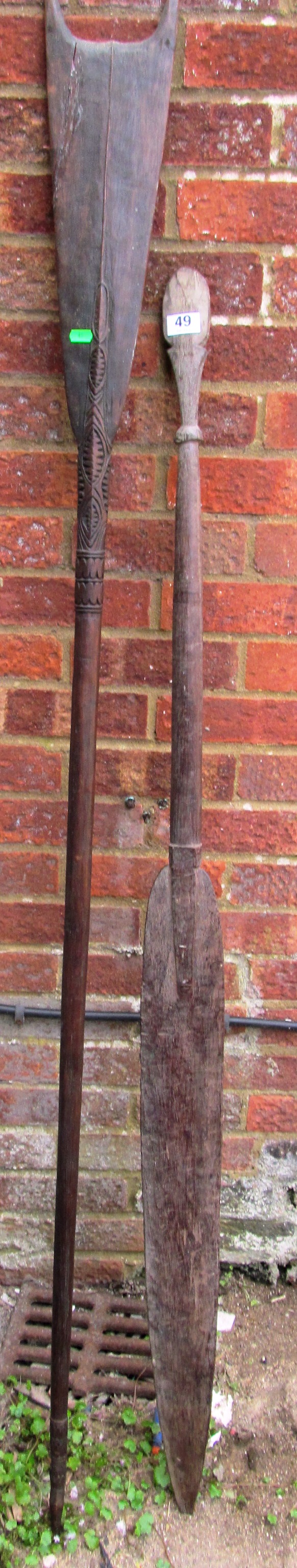 An African carved paddle and 1 from papua new guinea