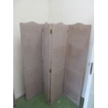 A four fold screen covered in beige fabric