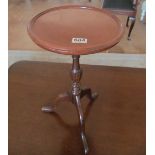 A circular topped wine table