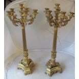 A pair of tall decorative gilt candelabra fluted columns, central candleholder and five others (