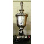 A chrome finish urn shaped table lamp