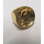 A heavy gold-coloured ring set in concave and eagle